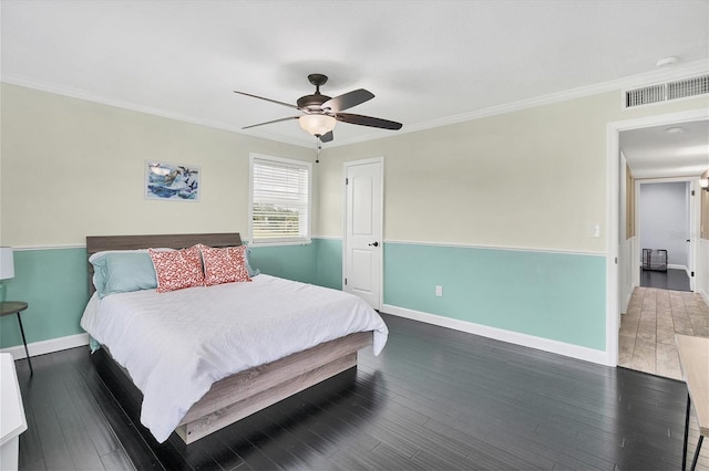 bedroom with ornamental molding, ceiling fan, and dark hardwood / wood-style flooring