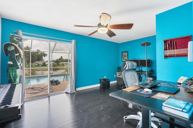 office space featuring hardwood / wood-style flooring, ceiling fan, and a textured ceiling