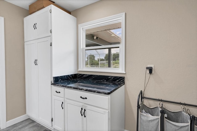 kitchen with white cabinetry and light wood-type flooring