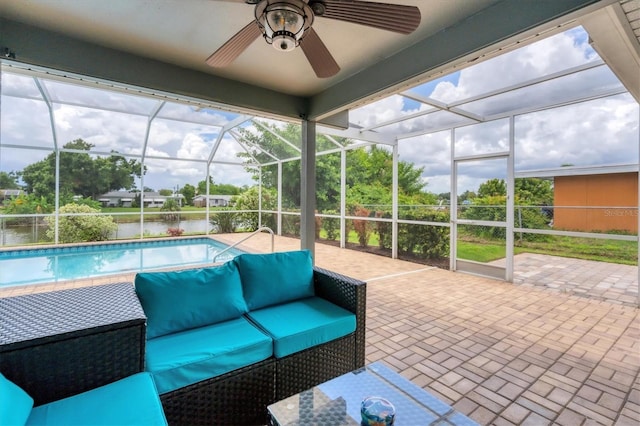 unfurnished sunroom featuring a water view and ceiling fan