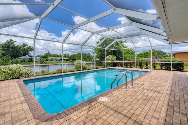 view of pool with a water view, a patio, and glass enclosure