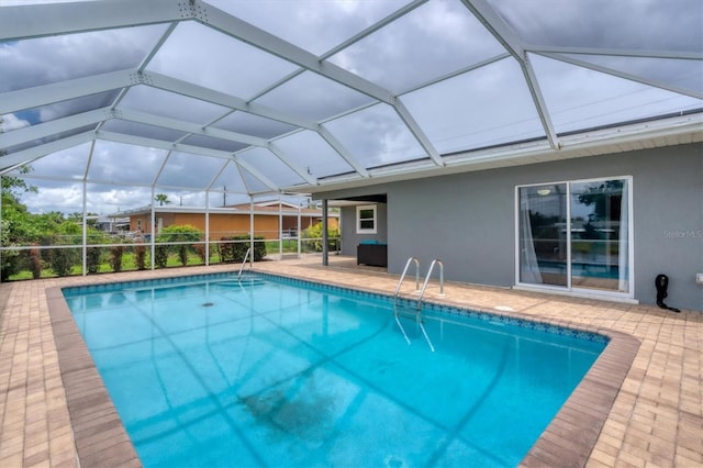 view of pool featuring a patio and glass enclosure