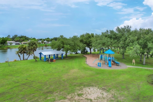 view of playground featuring a lawn and a water view