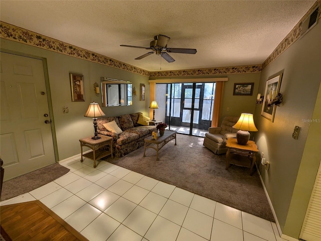 living room featuring ceiling fan, light colored carpet, and a textured ceiling