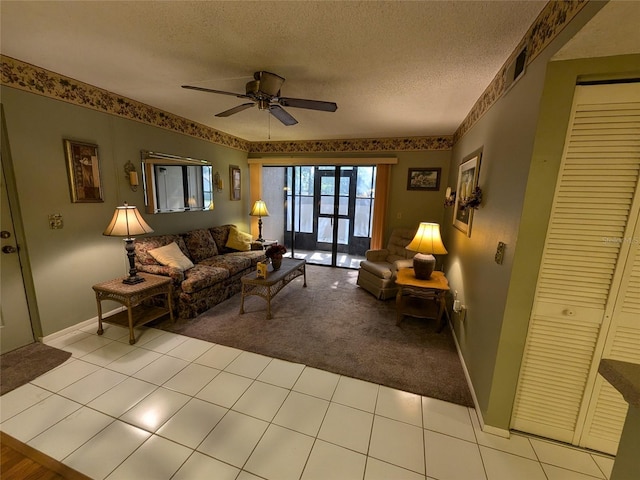 living room featuring ceiling fan, light colored carpet, and a textured ceiling