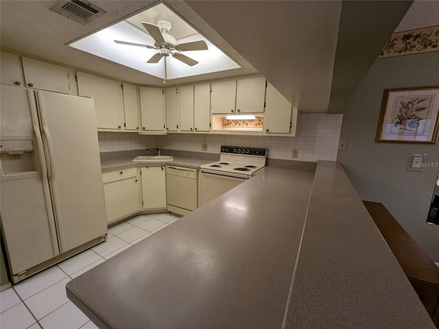 kitchen with sink, white appliances, light tile patterned floors, ceiling fan, and backsplash