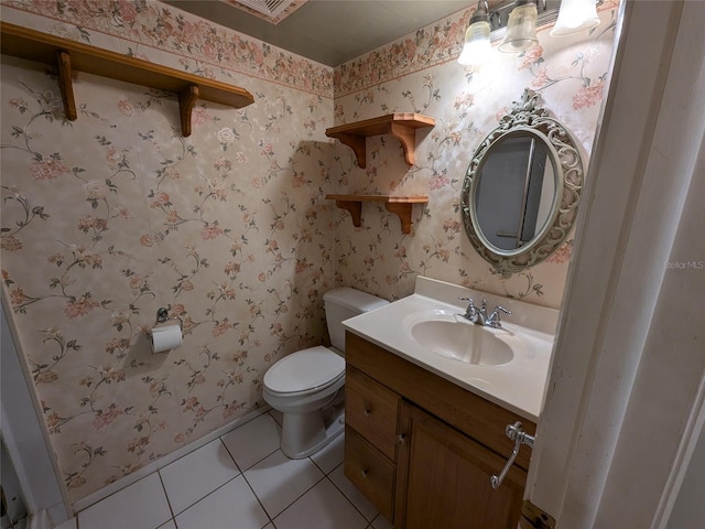 bathroom featuring vanity, toilet, and tile patterned flooring