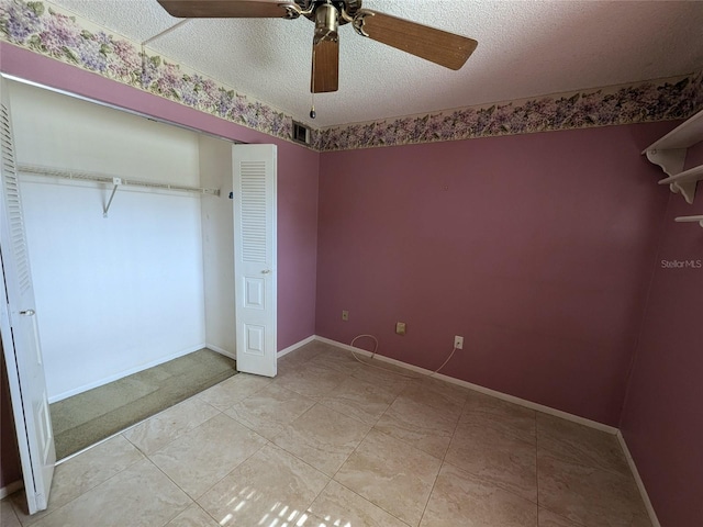 unfurnished bedroom with ceiling fan, light tile patterned flooring, and a textured ceiling