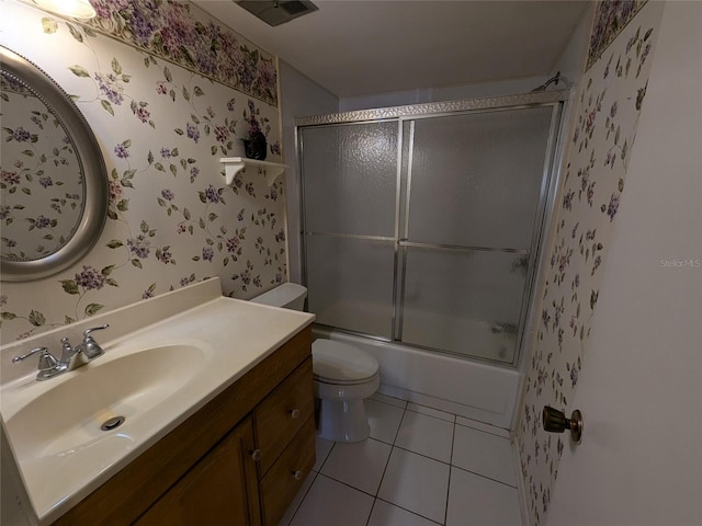 full bathroom with tile patterned flooring, vanity, shower / bath combination with glass door, and toilet