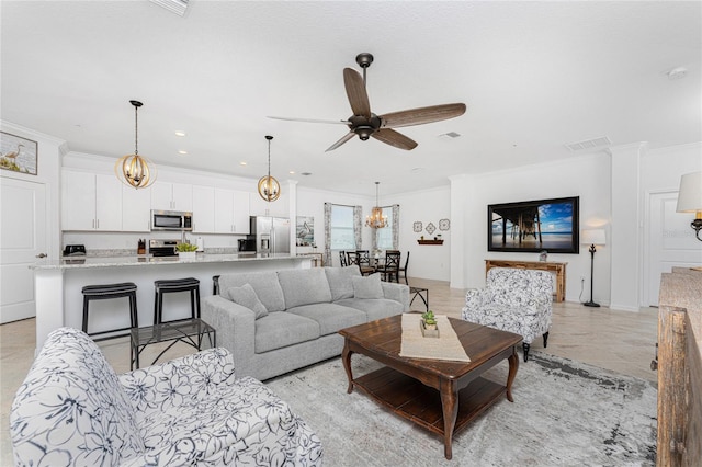 living room with ceiling fan and crown molding