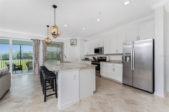 kitchen featuring white cabinetry, a center island with sink, stainless steel appliances, and sink