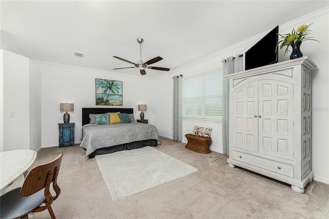 carpeted bedroom with ceiling fan and ornamental molding