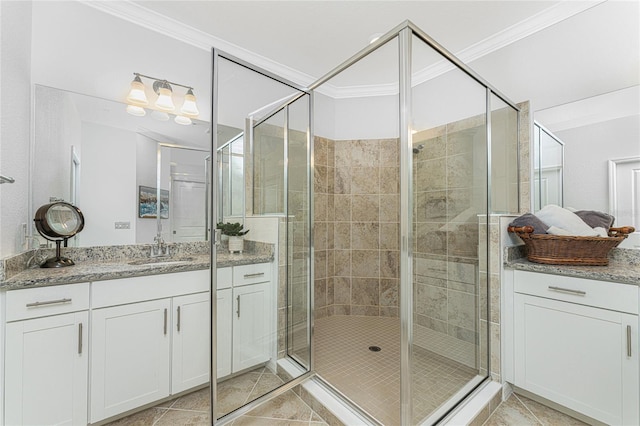 bathroom featuring tile patterned floors, vanity, an enclosed shower, and ornamental molding