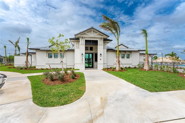 view of front of home featuring french doors and a front yard