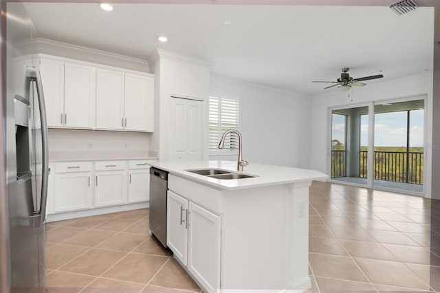 kitchen with sink, crown molding, white cabinetry, stainless steel appliances, and an island with sink