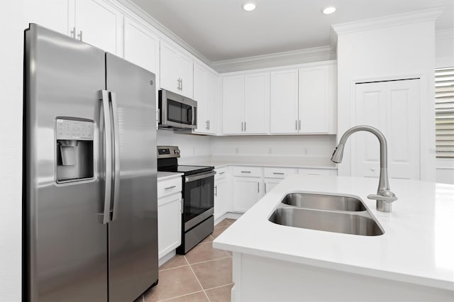 kitchen featuring sink, crown molding, light tile patterned floors, stainless steel appliances, and white cabinets