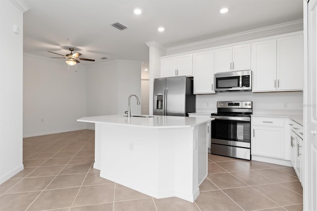 kitchen featuring appliances with stainless steel finishes, sink, a kitchen island with sink, and white cabinets