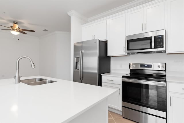 kitchen featuring white cabinetry, sink, light tile patterned floors, ceiling fan, and stainless steel appliances