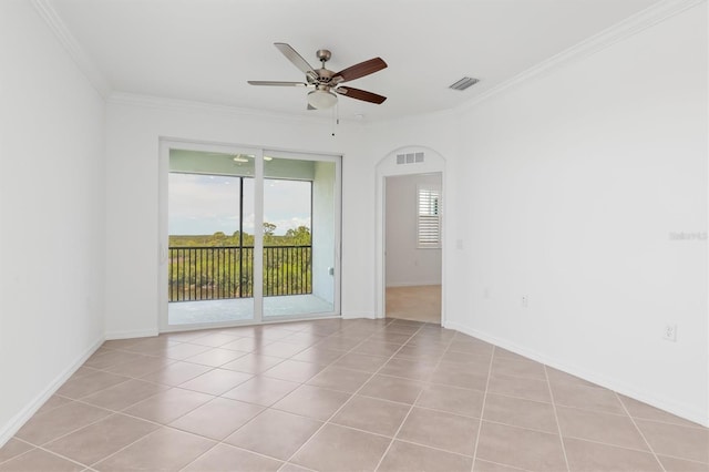 spare room featuring crown molding, ceiling fan, and light tile patterned flooring