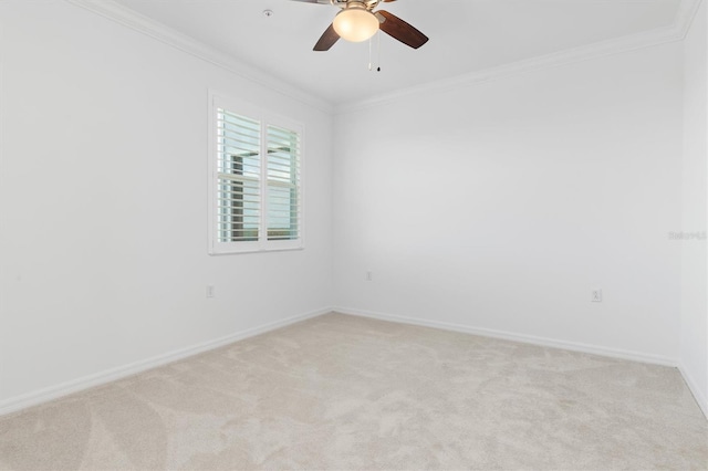 carpeted spare room featuring ornamental molding and ceiling fan