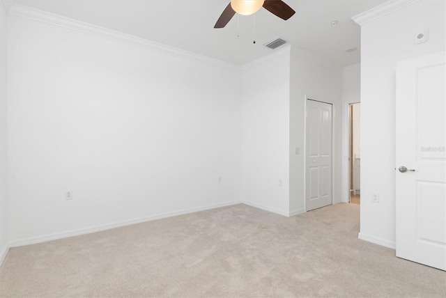 unfurnished room featuring light carpet, ornamental molding, and ceiling fan