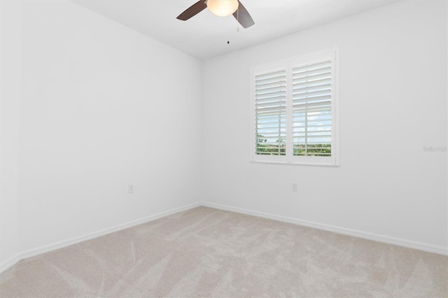 empty room featuring light carpet and ceiling fan