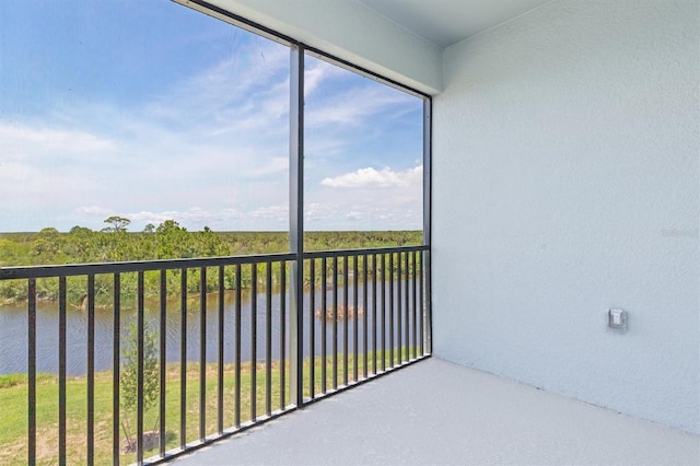 unfurnished sunroom with a water view