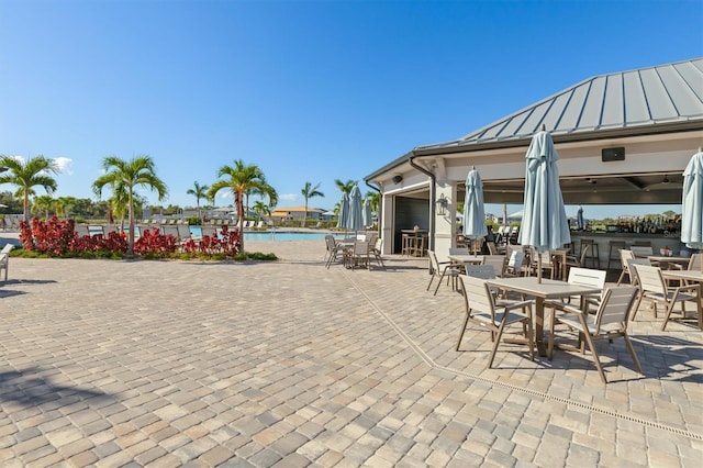 view of patio featuring a community pool and an outdoor bar