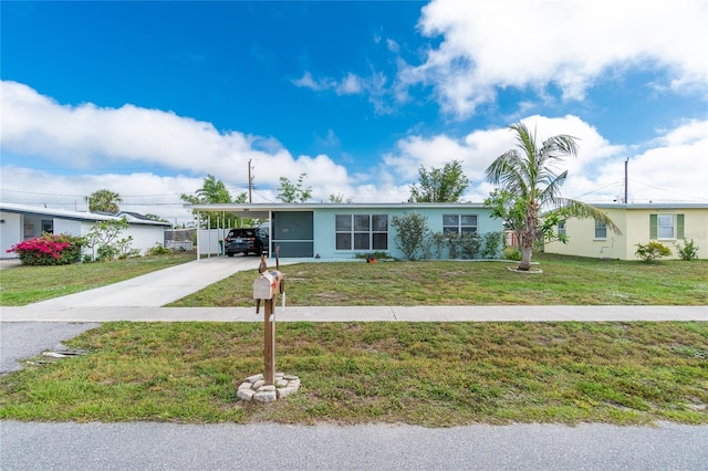 22062 Marshall Ave, Port Charlotte, FL 33952 - ranch-style home with concrete driveway, a carport, a front lawn, and stucco siding