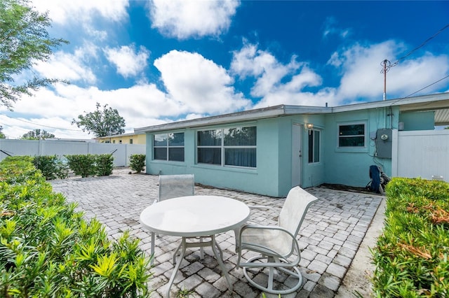 22062 Marshall Ave, Port Charlotte, FL 33952 - back of property featuring a patio, a fenced backyard, and stucco siding