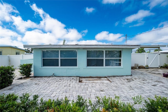 22062 Marshall Ave, Port Charlotte, FL 33952 - rear view of property with a gate, a patio, and stucco siding