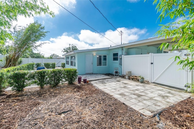 22062 Marshall Ave, Port Charlotte, FL 33952 - back of house with a gate, a patio area, and stucco siding