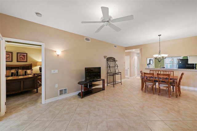 dining space with light tile patterned floors and ceiling fan with notable chandelier