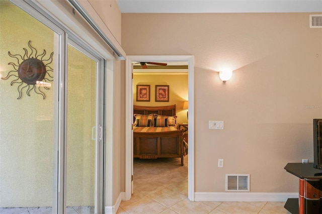 hall with light tile patterned floors