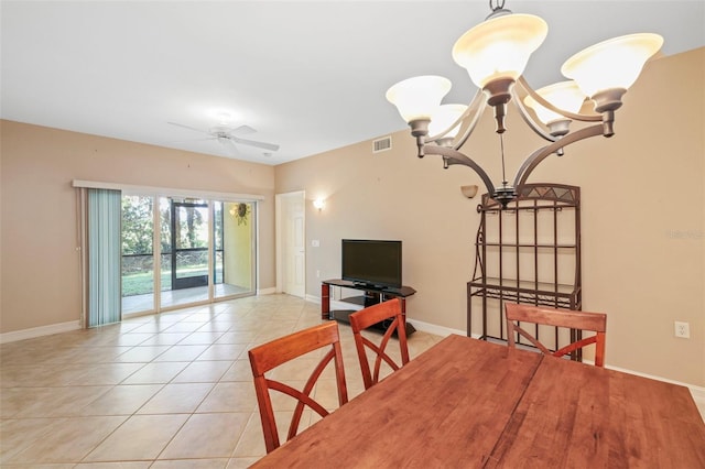 tiled dining space featuring ceiling fan with notable chandelier