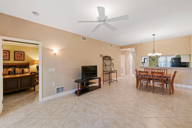 dining room with ceiling fan with notable chandelier and light tile patterned floors