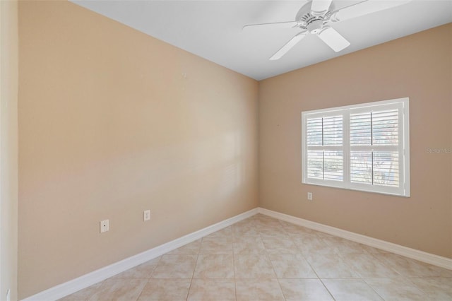 tiled spare room with ceiling fan