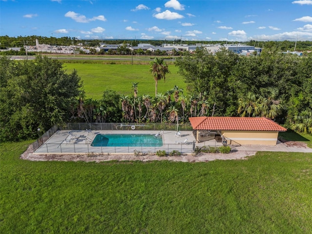 view of swimming pool featuring a patio area and a yard