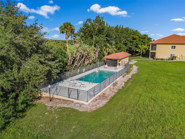 view of swimming pool with a lawn and a patio