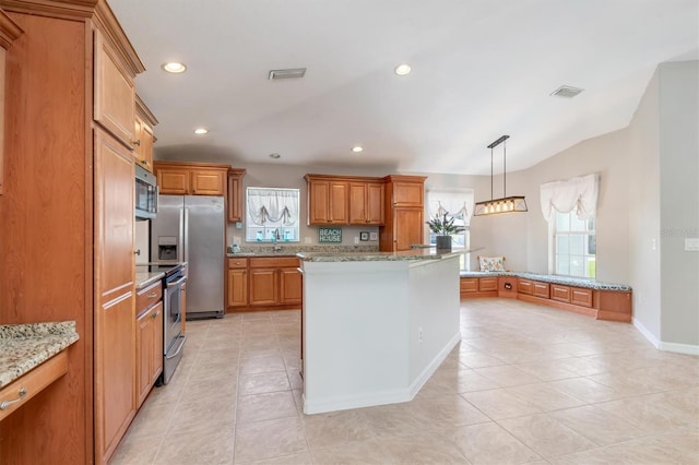 kitchen with decorative light fixtures, a center island, light tile patterned floors, light stone counters, and stainless steel appliances