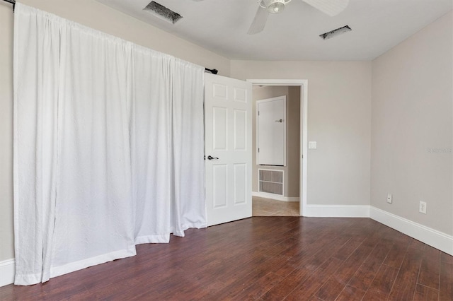 spare room with ceiling fan and dark hardwood / wood-style floors