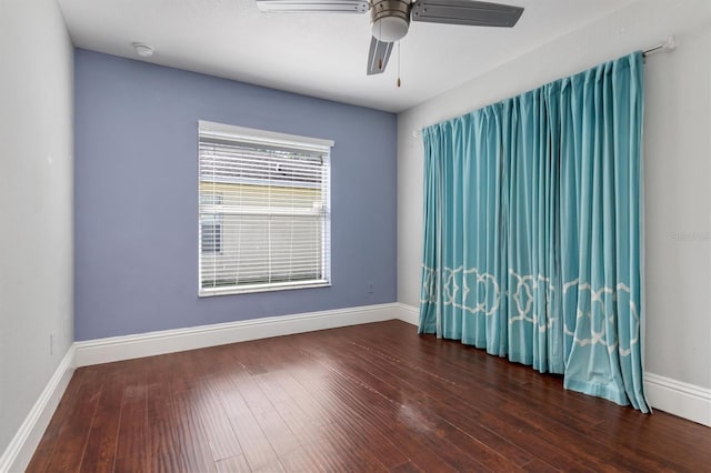 unfurnished room featuring dark wood-type flooring and ceiling fan