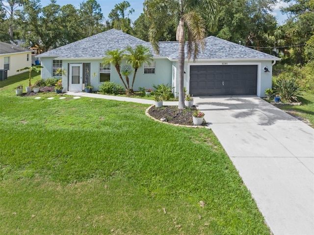 ranch-style house featuring a garage and a front lawn