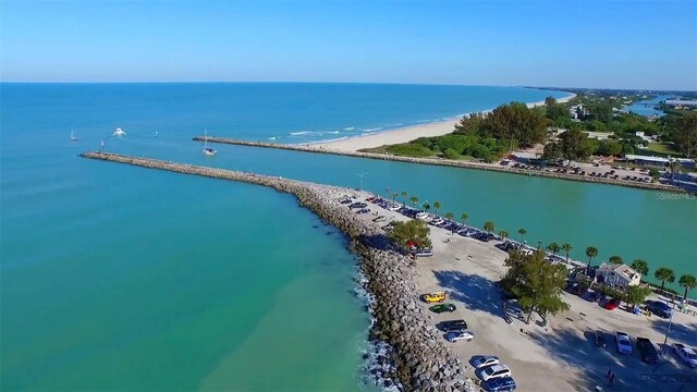 drone / aerial view with a water view and a view of the beach