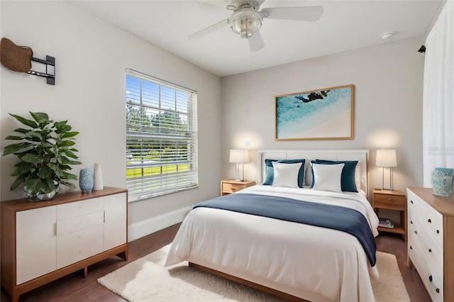 bedroom with dark hardwood / wood-style floors and ceiling fan