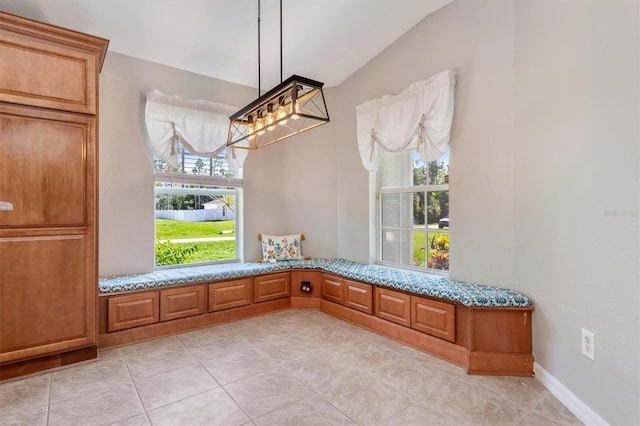 mudroom featuring lofted ceiling and light tile patterned floors