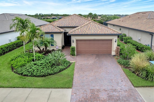 view of front of home featuring a garage and a front yard