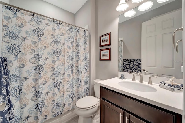 bathroom featuring vanity, toilet, and curtained shower