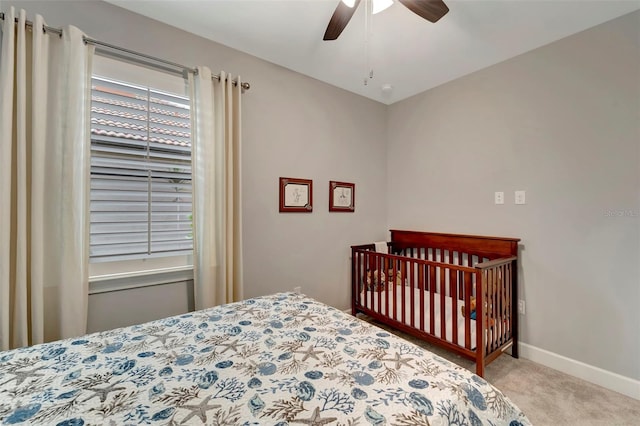 bedroom with ceiling fan and light carpet