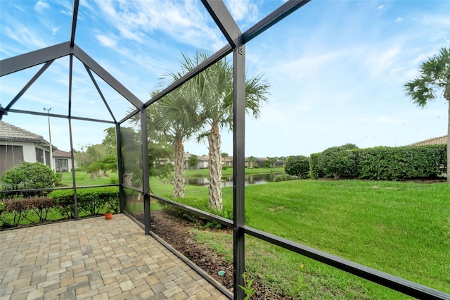 unfurnished sunroom with a water view